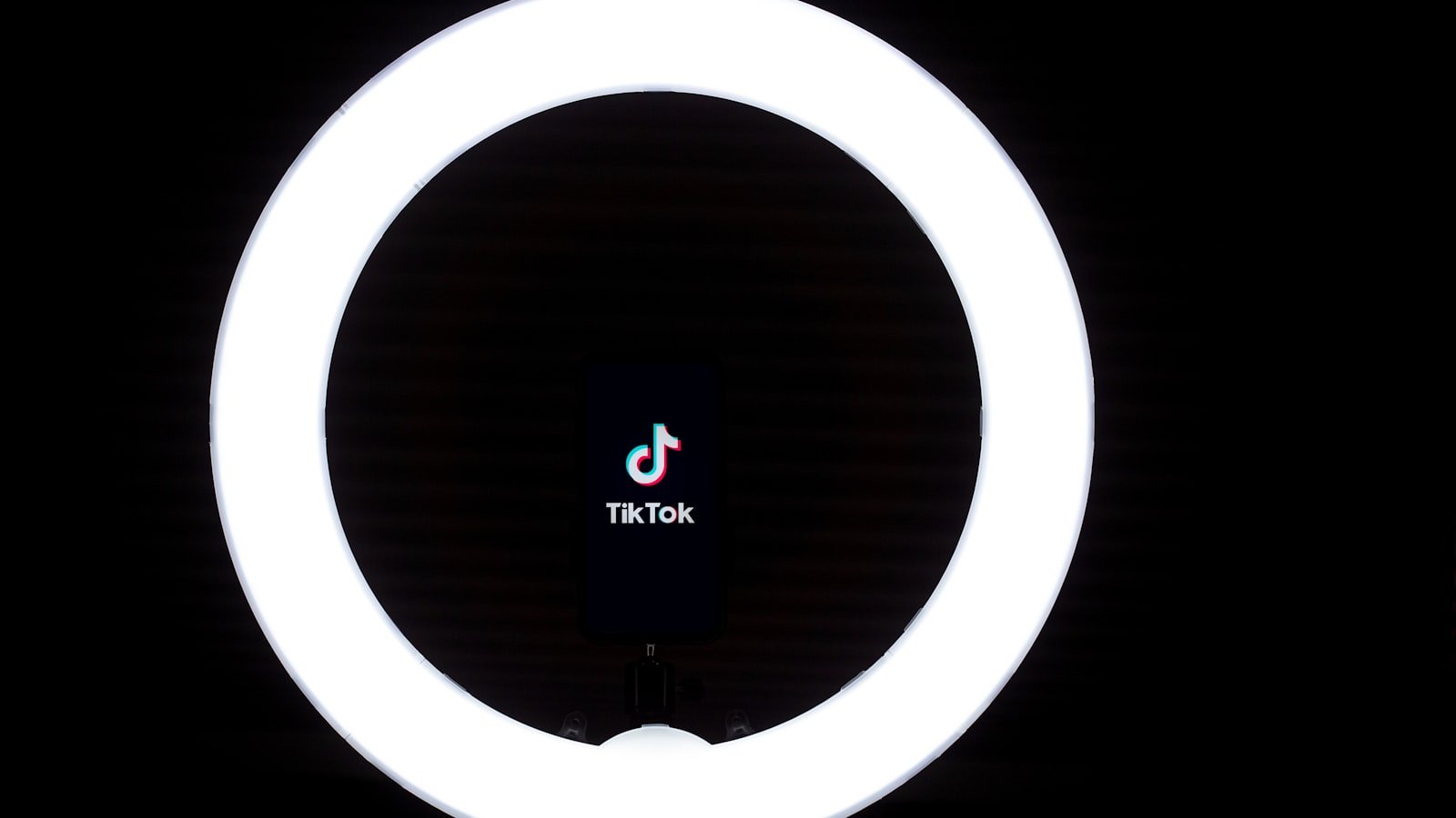 A smartphone set up on a stand for filming vertical video
